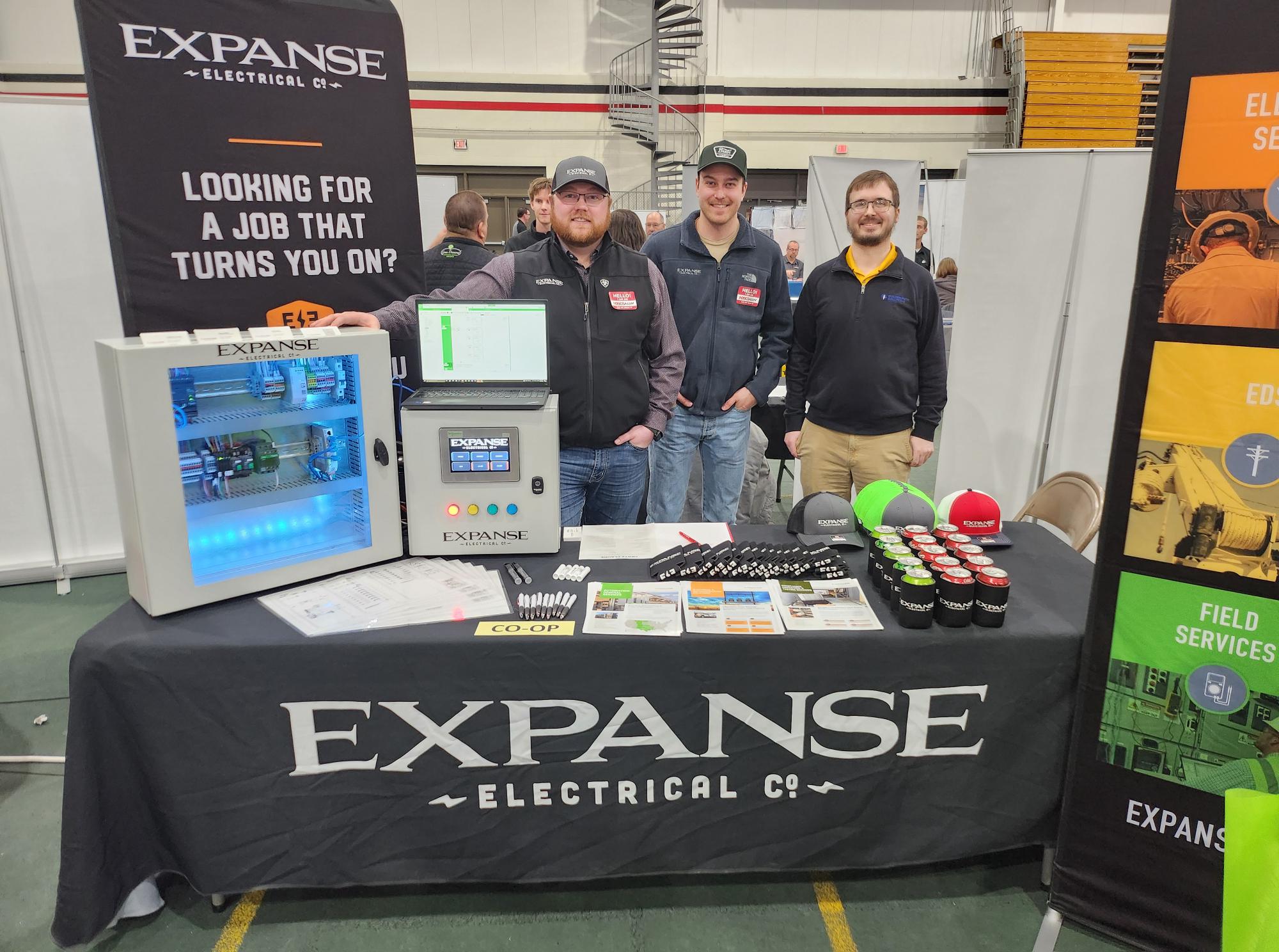 A Golden Path employee and two Expanse employees are pictured at the Expanse table at the NDSCS Career Fair