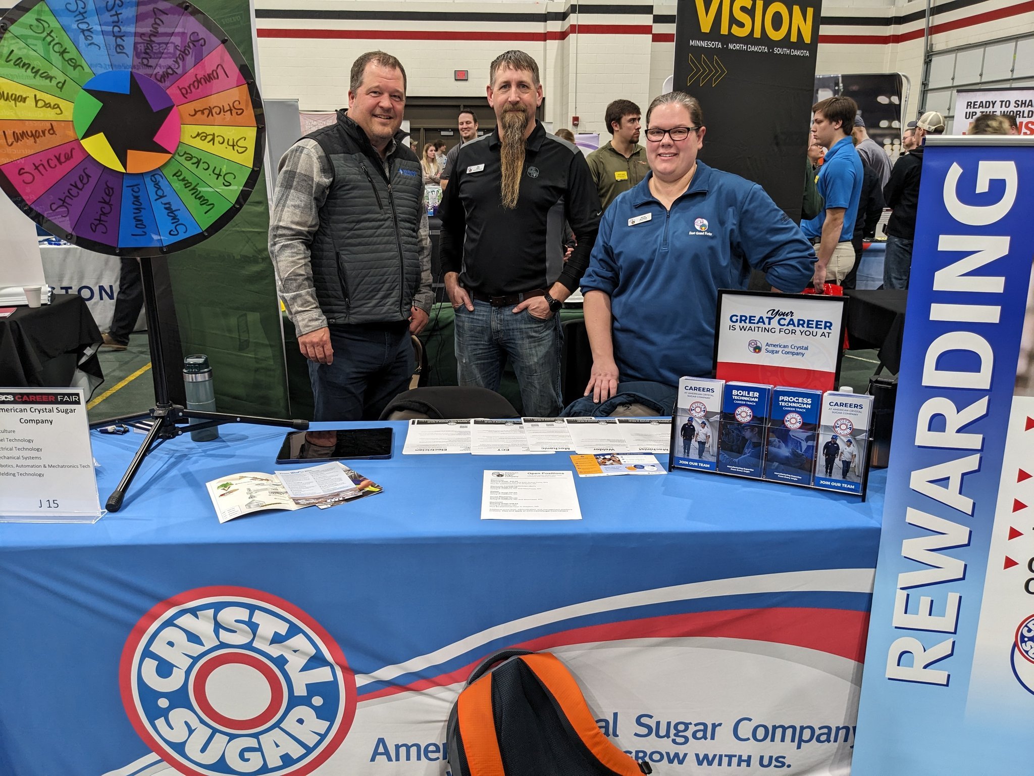 A Golden Path employee at two American Crystal Sugar employees are pictured at the American Crystal Sugar table at the NDSCS Career Fair