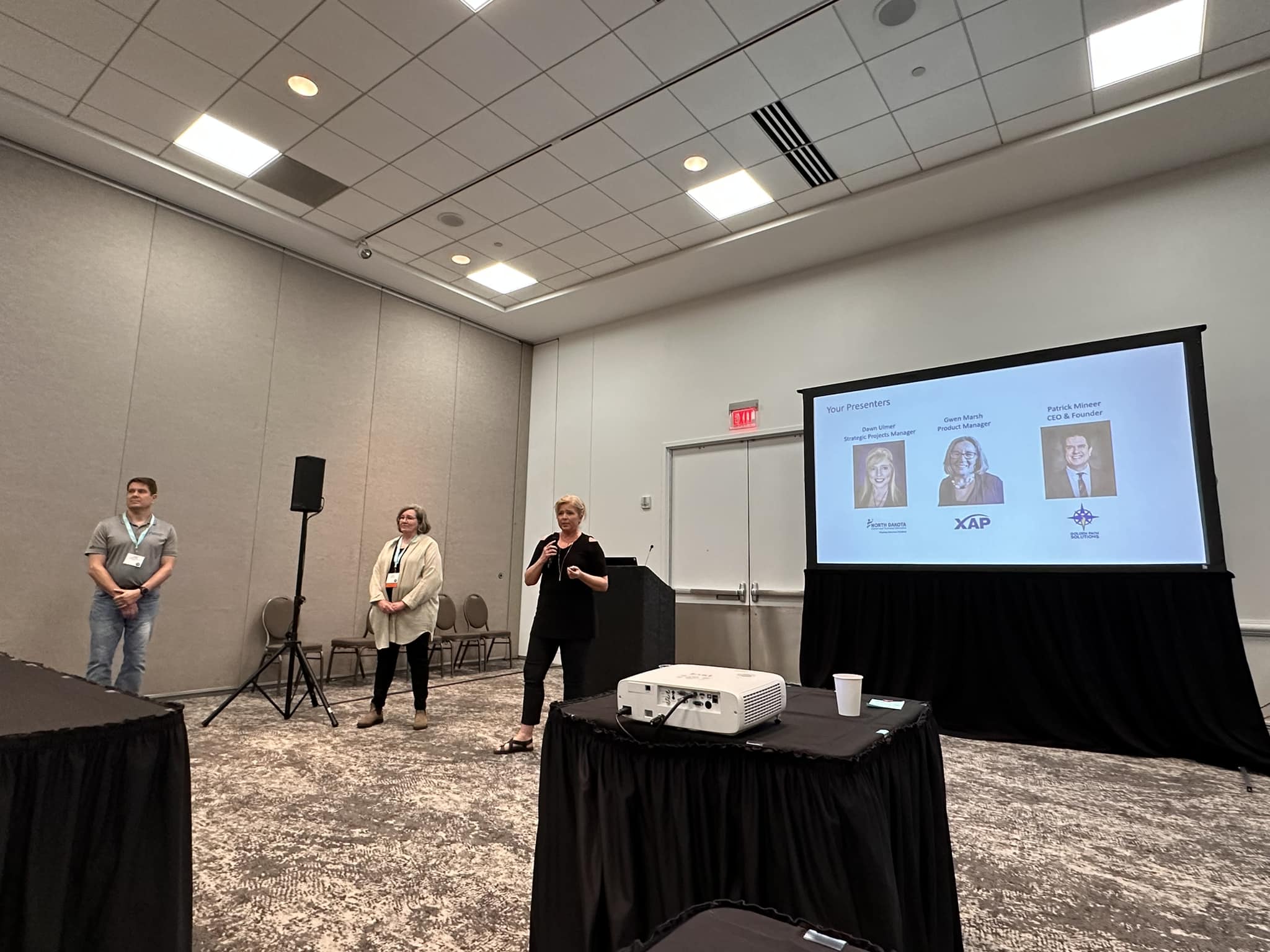 Three people are presenting at a national work-based learning conference