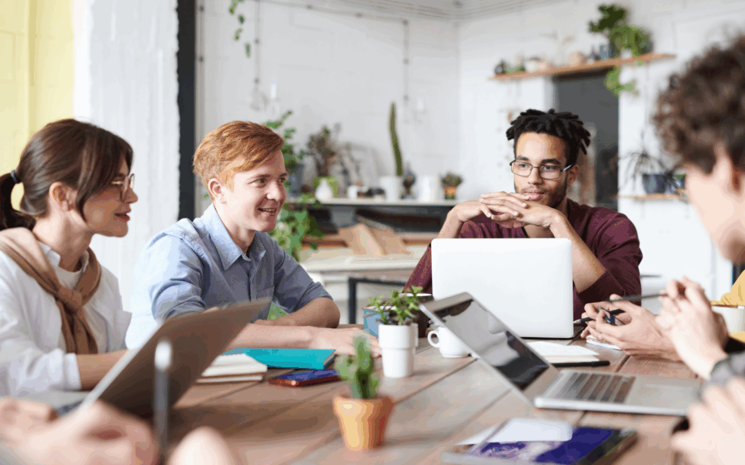 four college students visit while sitting together at a table