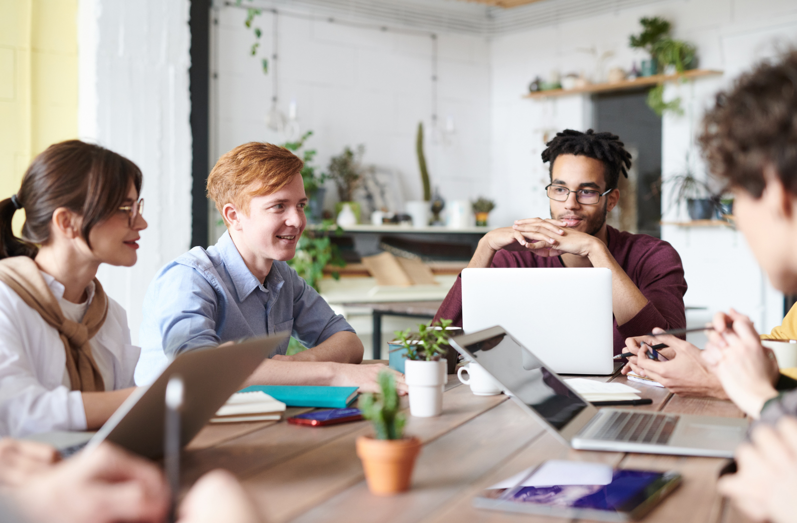 four college students visit while sitting together at a table