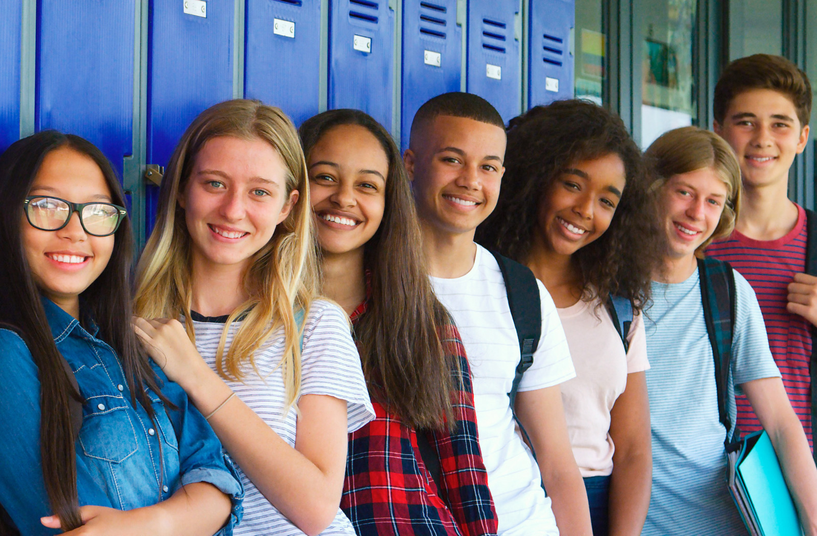 Connecting with Students with Career Profiles A group of seven students stand in a line in front of blue lockers