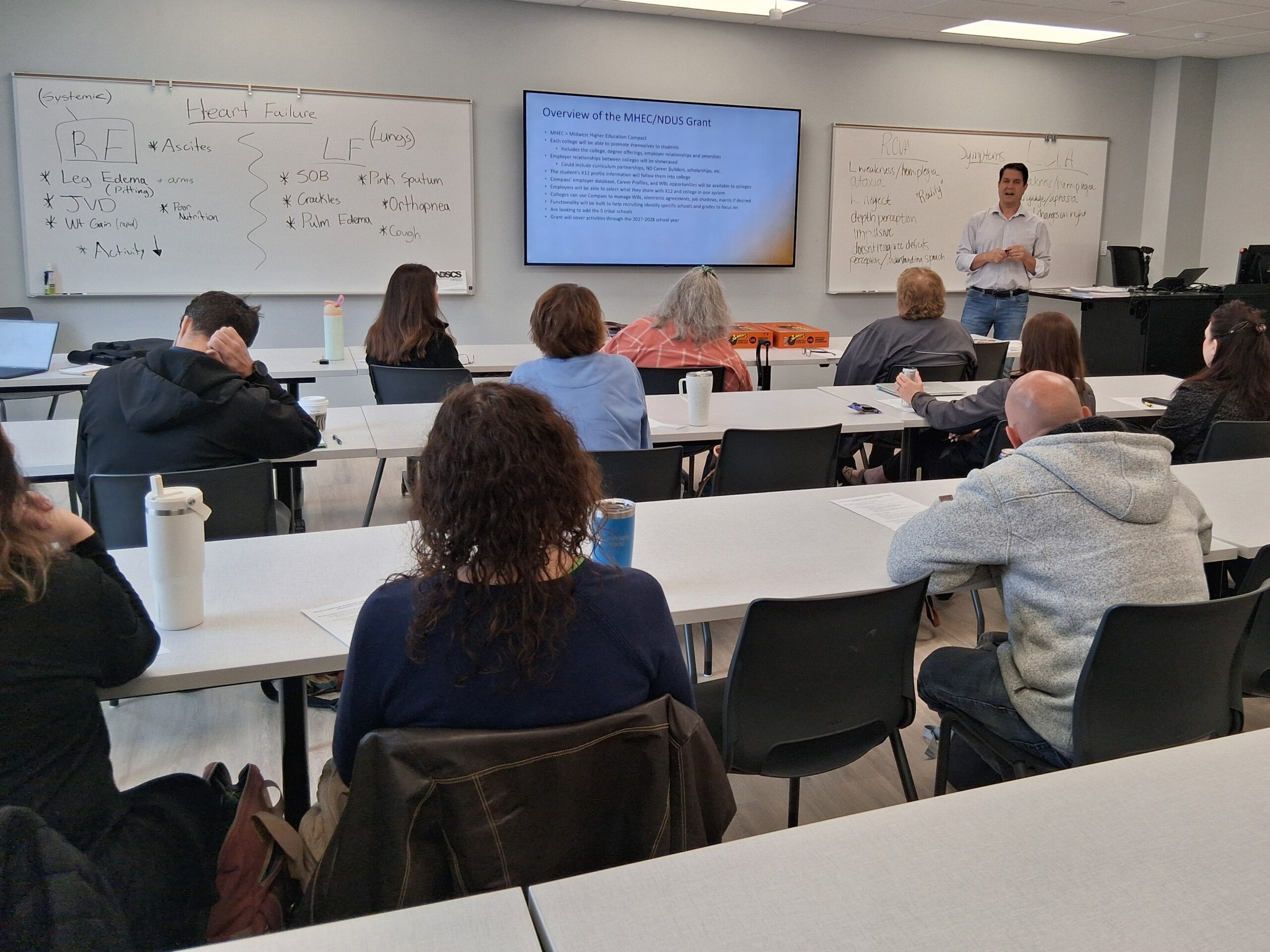 Patrick presents at a room full of school professionals