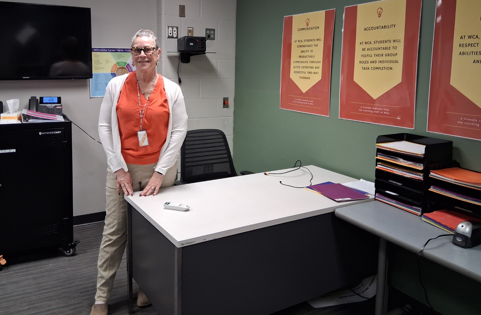 A teacher stands near her desk at West Center Academy in Moorhead